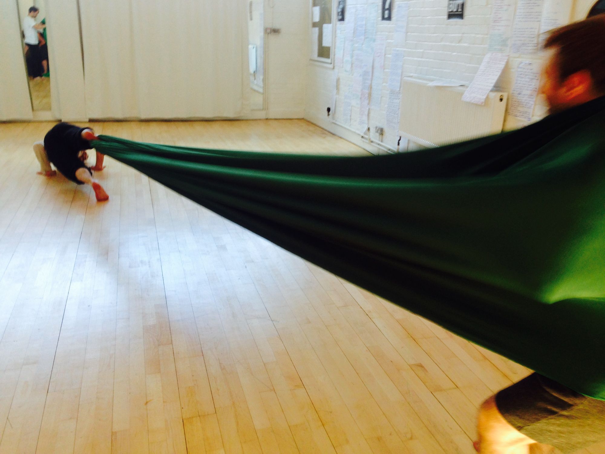 Working with Lou on interactive experience Invisible Treasure and thinking about risk in theatre. Ed and Barra, two young white men, play in a long stretchy loop of green material that Lou uses in her practice and brought to the devising room.